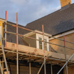 Scaffolding seen assembled around residential houses being built